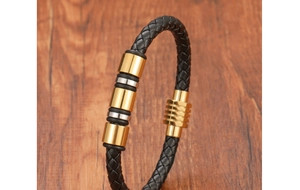 Détail macro du bracelet en cuir tressé noir avec anneaux en métal doré et argenté