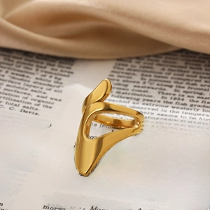 Macro detail of golden irregular geometric ring on vintage paper and satin fabric