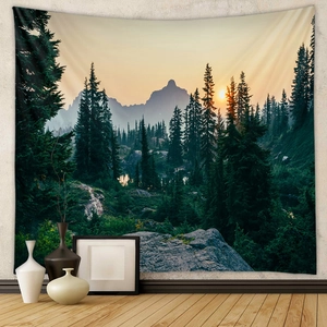 Detail view of a bohemian forest sunset tapestry hanging in a modern living room setup
