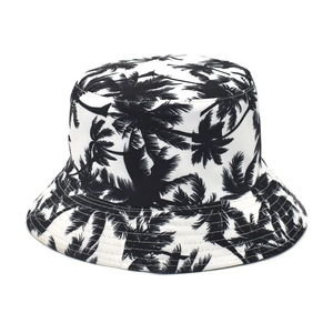 Close-up of tropical palm tree print on black and white canvas bucket hat fabric