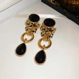 Vintage leopard head drop earrings with black gemstones and elegant gold plating