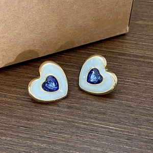 Elegant heart-shaped gold studs with blue crystal and white enamel inlay for women