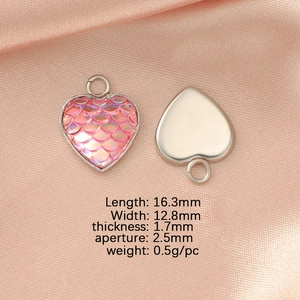 Detail showing heart-shaped stainless steel pendant with pink fish scale resin on silk