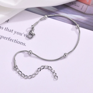 Detail of silver snake chain bracelet with polished beads and adjustable lobster clasp