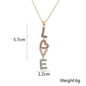 Gold plated copper LOVE pendant necklace with colorful zircon stones on white background