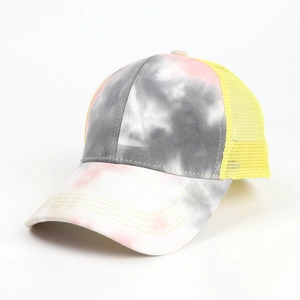 Detailed side view of tie-dye mesh baseball cap with yellow breathable mesh panel