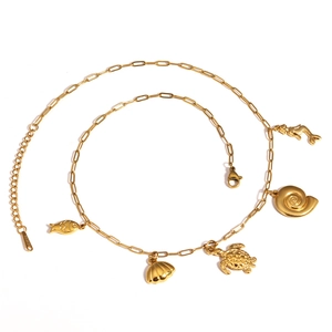 Detail of 18K gold plated stainless steel ocean charms with fish shell and sea turtle