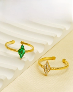 Detail of 18K gold plated rings with marquise cut zircon and hammered metal texture