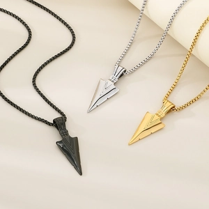 Detailed view of hip hop arrow pendant necklaces in black, silver, and gold steel finishes