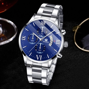 Detail of blue dial business watch with silver steel band and Roman numerals on dark surface