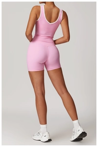 Detail of pink cross high-waist yoga set showing slim fit fabric and white piping trim