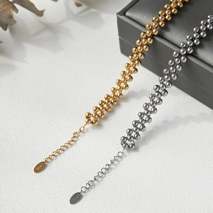 Three-strand beaded bracelet in gold and silver finish with K18 tag and extender chain