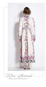 Rear view of floral printed dress with stand collar and lace hem detail on white backdrop