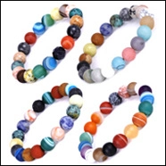 Detailed view of four beaded bracelets featuring natural tiger eye and turquoise stones