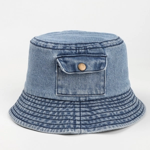 Detailed macro view of denim bucket hat featuring vintage pocket and metal button