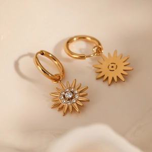 Golden stainless steel hoop earrings featuring sunburst zircon pendants in a warm setting