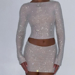 Sparkly silver rhinestone two-piece set featuring long sleeve crop top and mini skirt