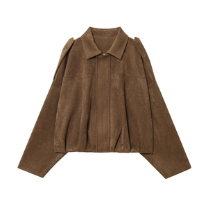 Detail of dark brown faux suede bomber jacket with shoulder tabs and soft brushed texture