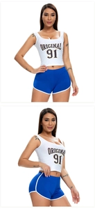 Detail view of women's blue yoga shorts and white cropped tank top with side view