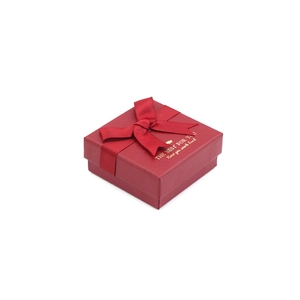 Elegant red square jewelry gift box featuring a ribbon bow and gold foil text