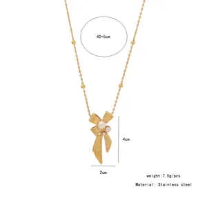 Detail view of golden bow necklace with pearl fringe and stainless steel dimensions