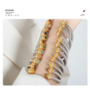 Stacked stainless steel cable bracelets with multicolored zircon stones and pavé accents