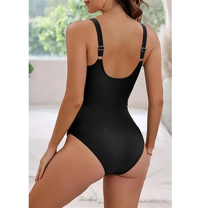 Detail view of black one-piece swimsuit featuring an elegant backless design and thin straps
