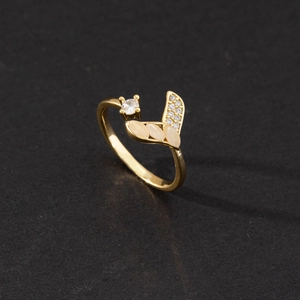 Detail of adjustable gold ring with leaf design, cubic zirconia, and opal-like stones