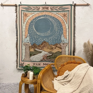 Detail of bohemian tarot moon woven tapestry with decorative fringe and wall display