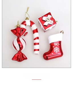 Close-up of red and white Christmas ornaments including candy cane, boot, and gift box