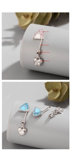 Macro detail of titanium cartilage earring with cat ear top and heart-shaped pendant