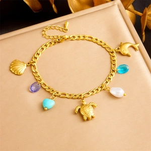 Gold ocean charm bracelet with sea turtle, dolphin, shell charms and colorful gems