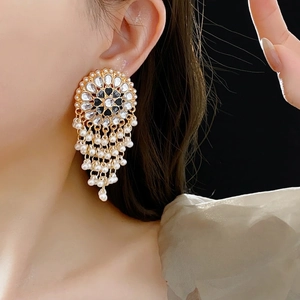 Vintage gold drop earrings with crystal sunburst and cascading white pearl tassels