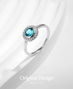 Macro view of S925 sterling silver ring with blue gemstone and pavé diamond halo