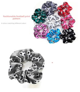 Detailed view of eight assorted satin soccer print hair scrunchies in various colors