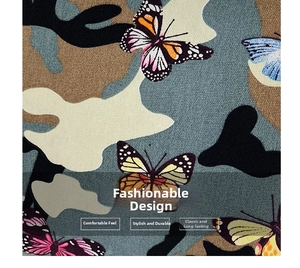 Macro shot of canvas fabric featuring camo patterns and colorful butterfly prints