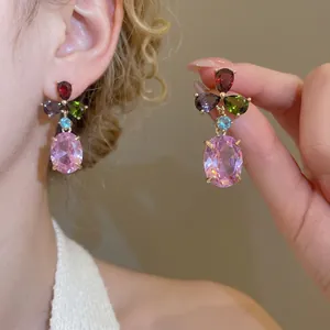 Elegant gold drop earrings featuring colorful zircon stones and purple oval crystal gems