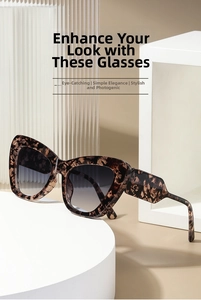 Close-up of cat-eye sunglasses with dark tortoise frames and gradient lenses on props