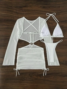 Flat lay of white three-piece mesh swimsuit set featuring drawstring details and a skirt