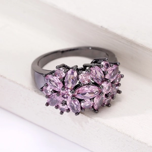 Macro shot of cluster ring with marquise-cut lavender gems on a black metal band