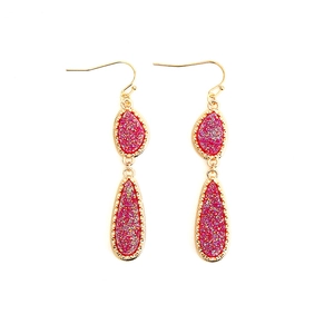 Detail of rose red crystal drop earrings with textured gold glitter in teardrop shapes
