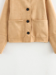 Detail of camel suede jacket featuring three black buttons and large patch pockets