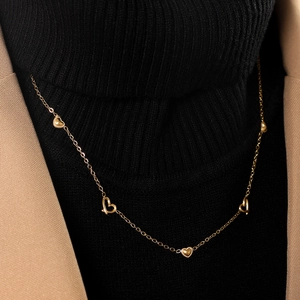 Elegant rose gold heart necklace with solid and hollow charms on a classic fine link chain