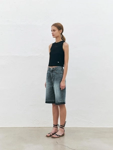 Women's vintage blue high-waist denim shorts with black knit sleeveless tank top