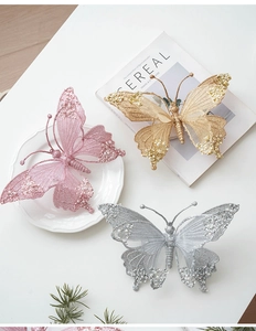 Close-up of sparkling Christmas butterfly ornaments with glitter, sequins and pearls