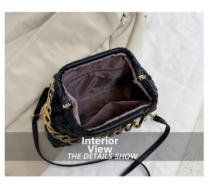 Detail view of spacious black quilted bag interior with purple lining and zipper pocket