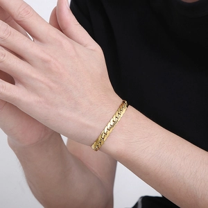 Polished gold Cuban link chain bracelet for men shown on a model wrist for daily wear