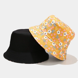 Reversible floral bucket hat for women in black and yellow with small flower patterns