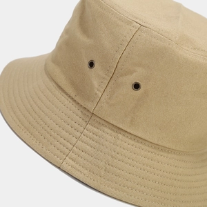 Detail of khaki cotton bucket hat with copper ventilation eyelets and reinforced stitching