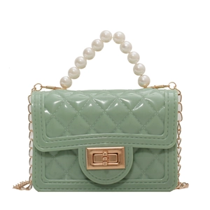 Green jelly handbag with pearl handle, diamond pattern, and gold chain strap